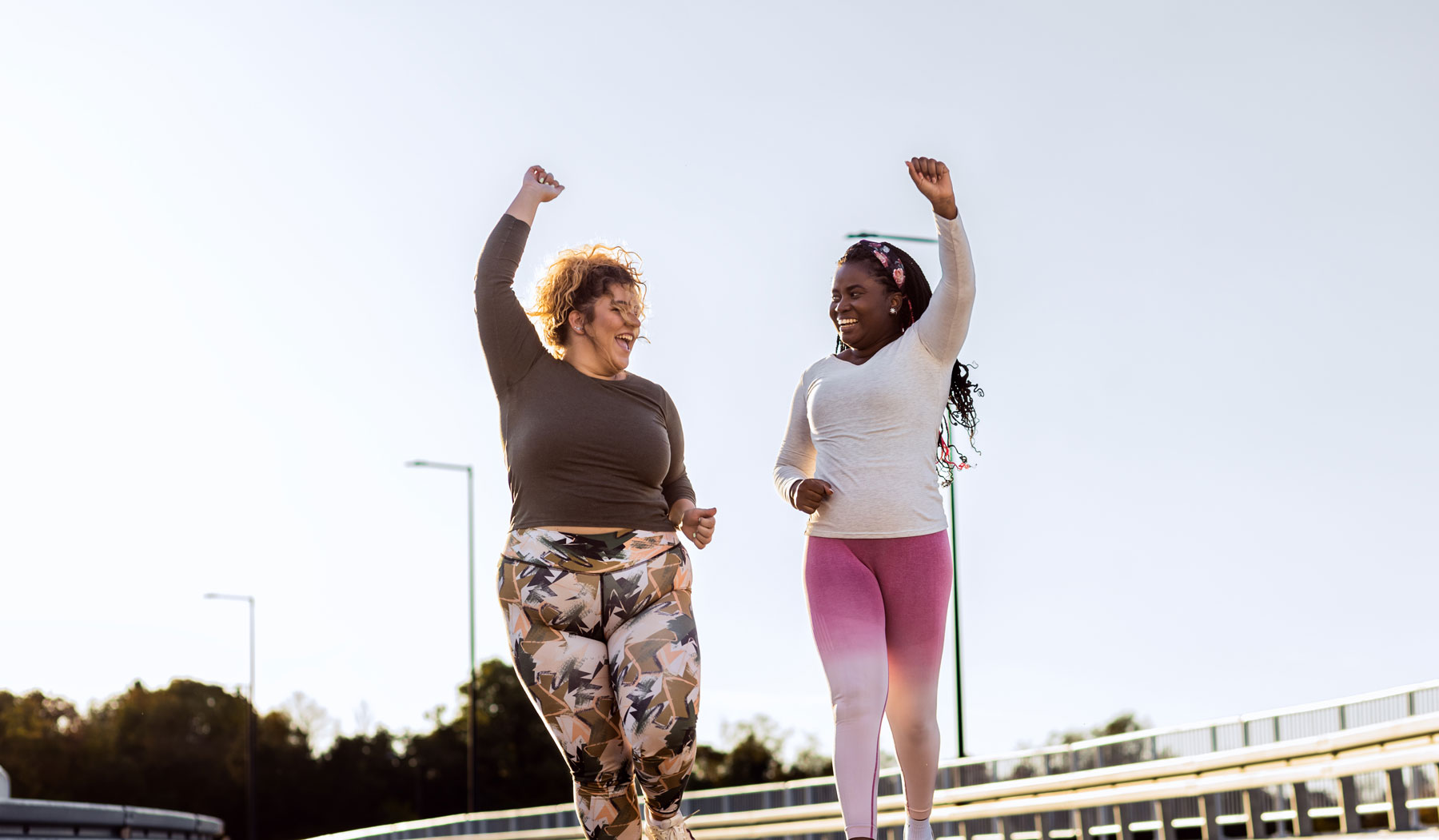 2 young women happy exercising and jogging together