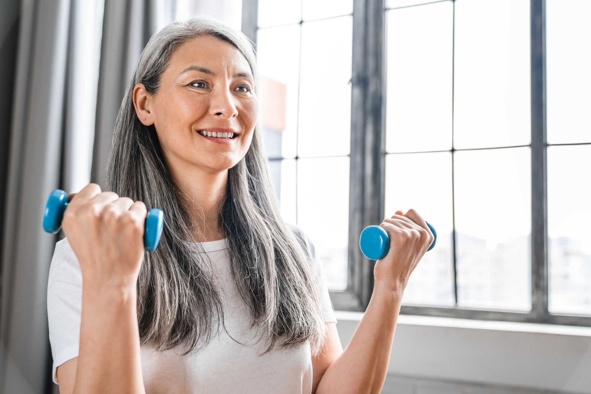 Woman working out with dumbbells.